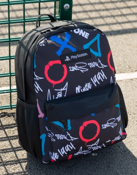 Black PlayStation backpack with colourful controller button symbols (X, O, △, □) and graffiti-style graphics